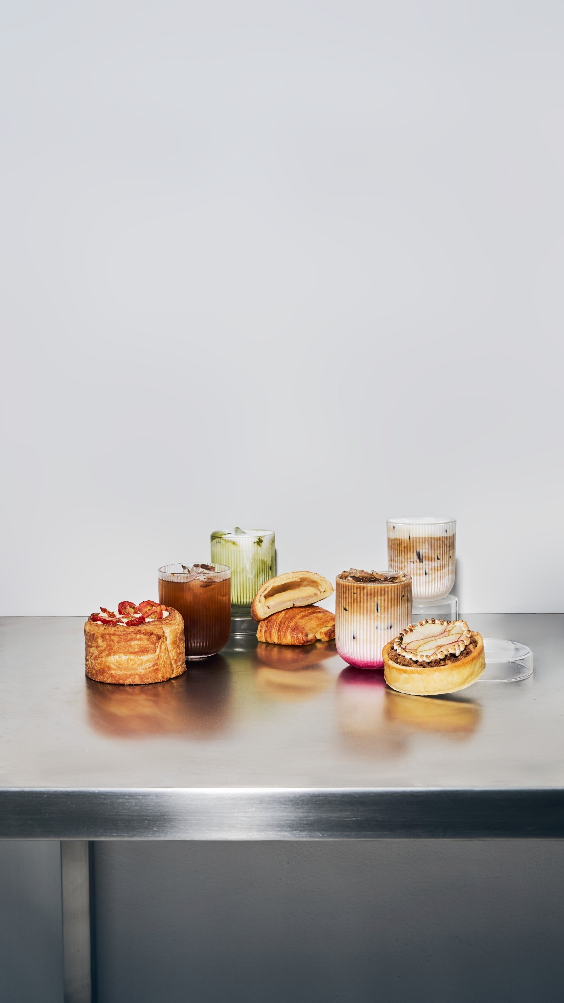 MATTER coffee, matcha and pastries on a stainless steel counter